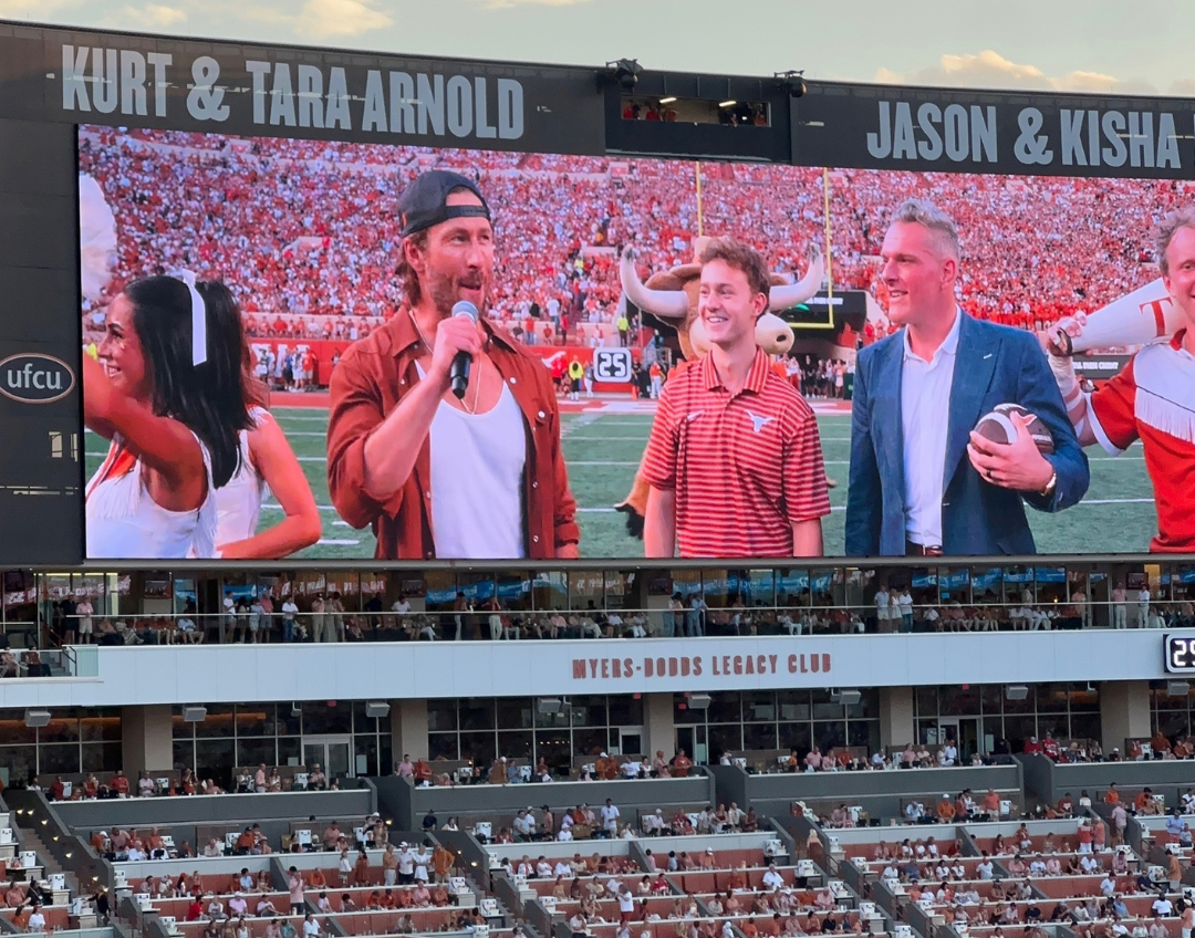 image of a screen with people on it at a football game