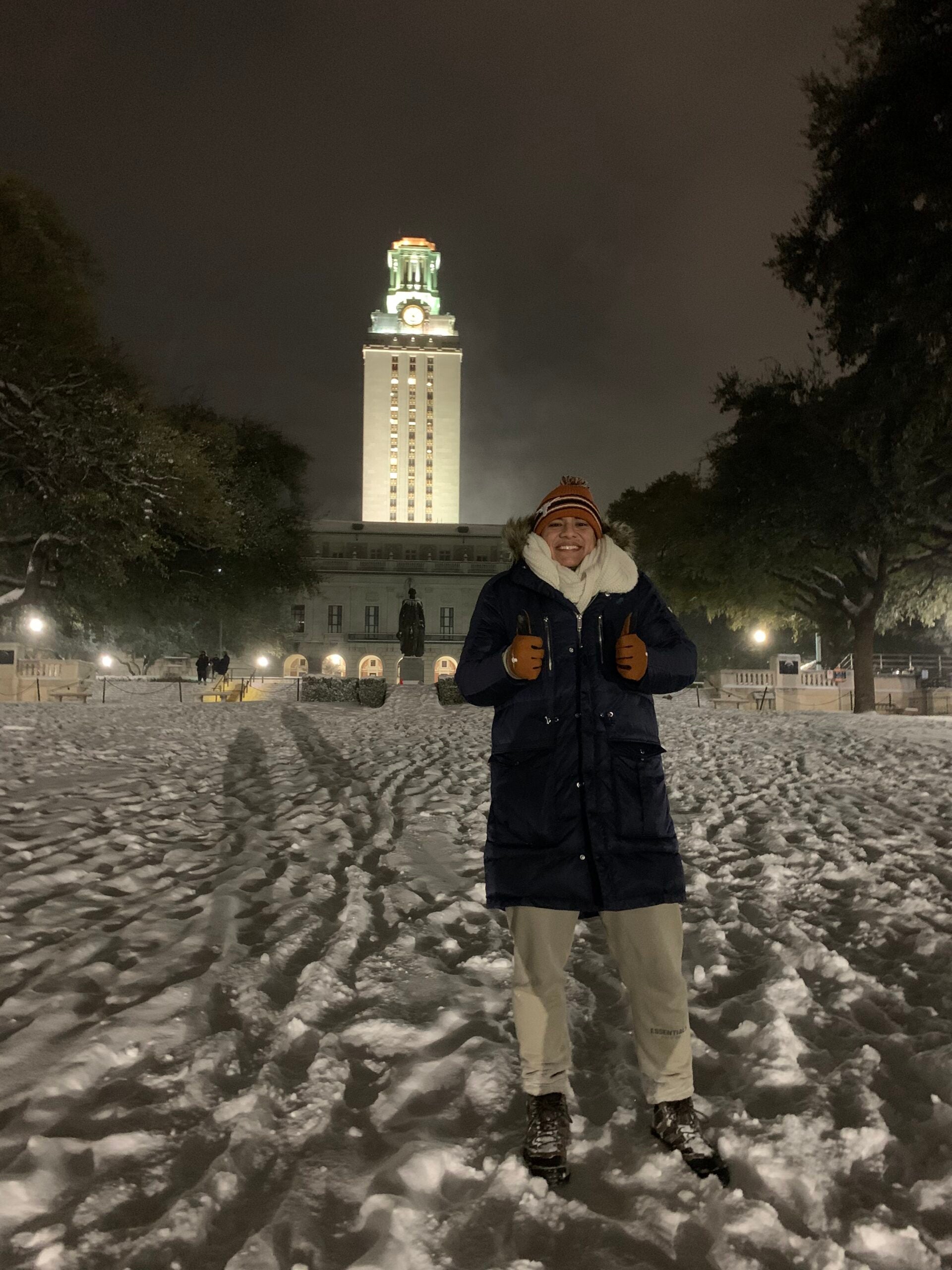 image of a student standing in the snow in front of the Tower