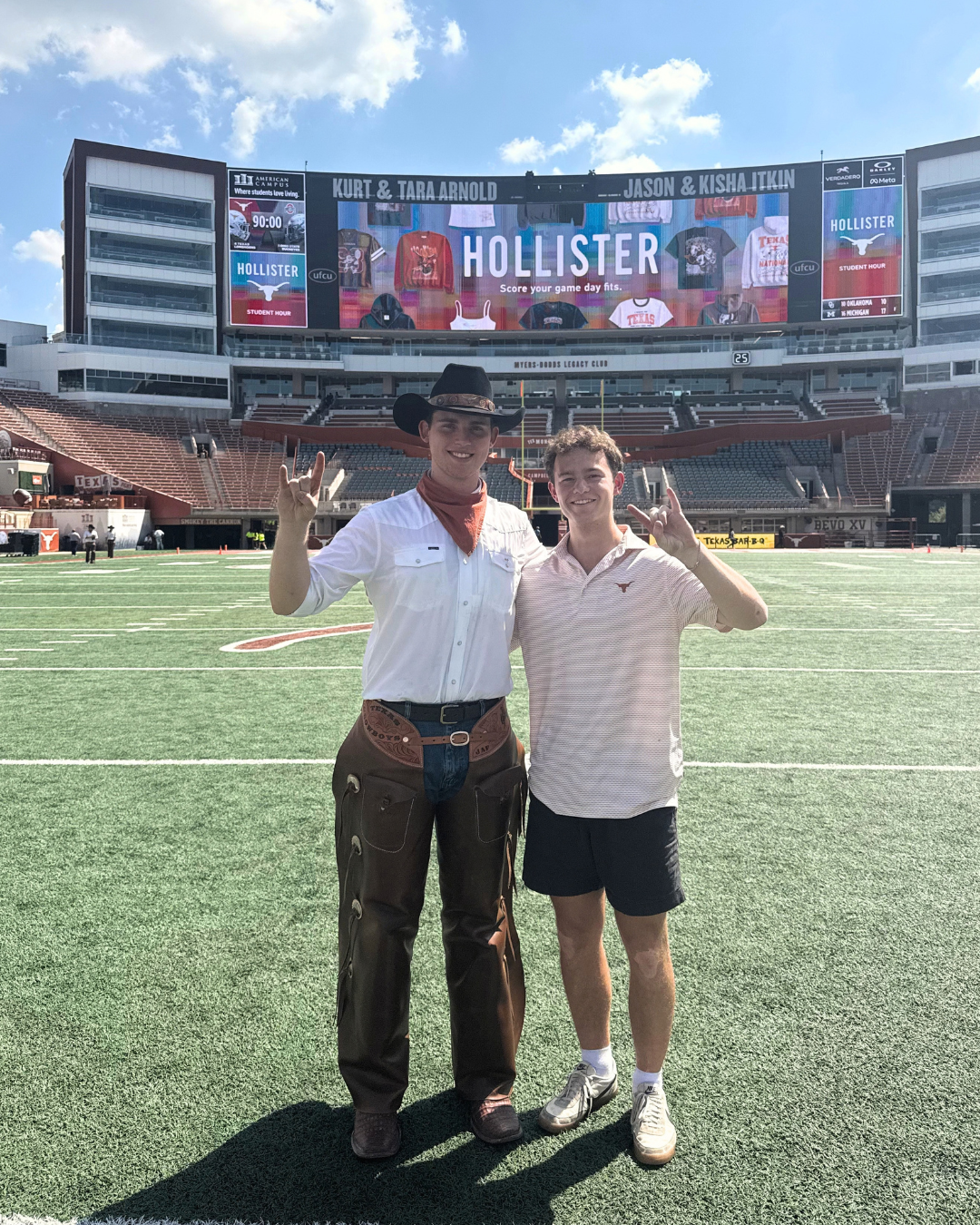 image of two students doing hook 'em