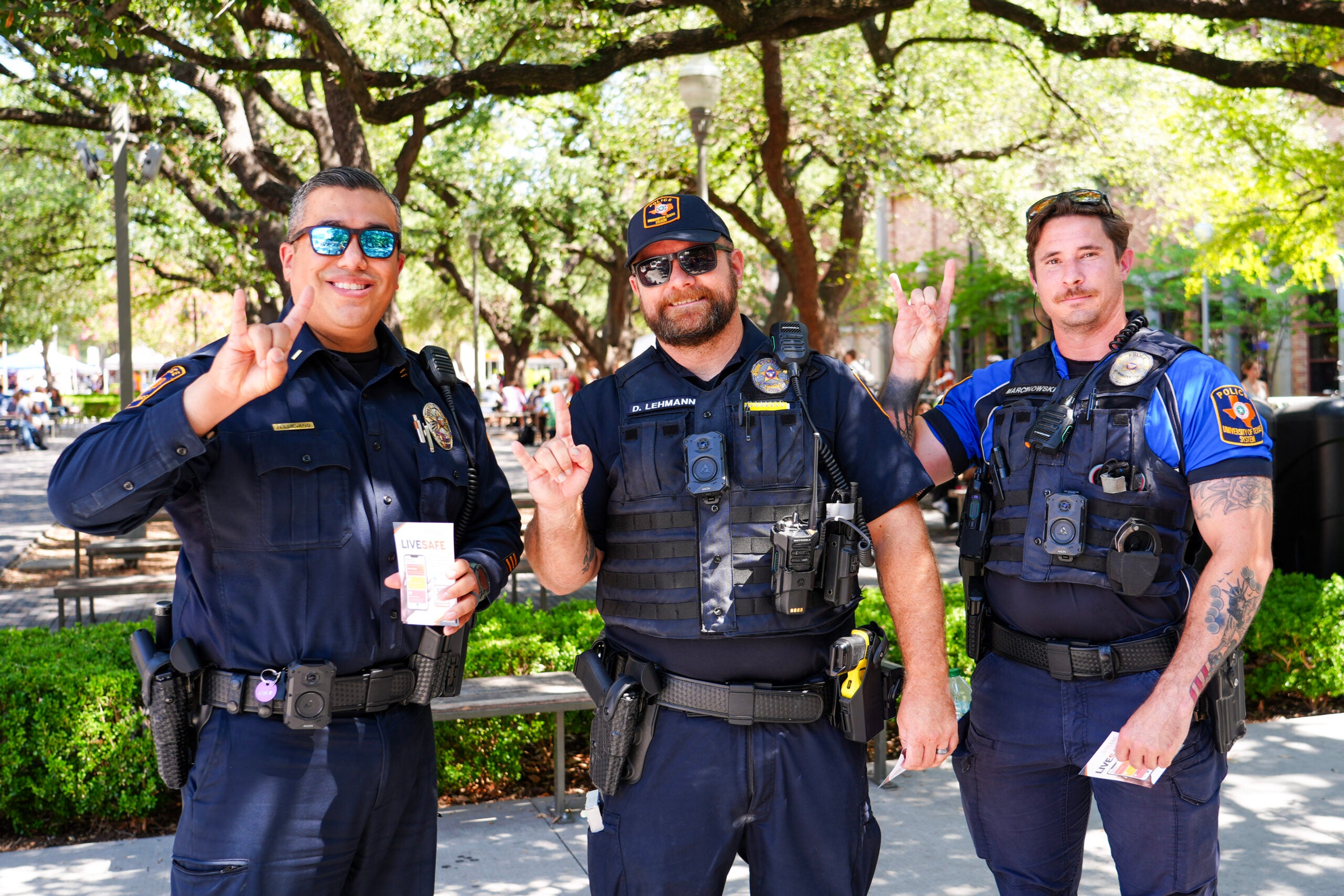 image of three police officers holding up hook 'em