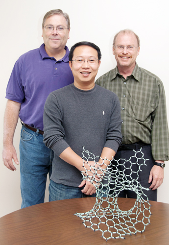 Meryl Stoller, Dr. Yanwu Zhu and Dr. Rodney Ruoff stand with a 3-D model of the new carbon material they have created.