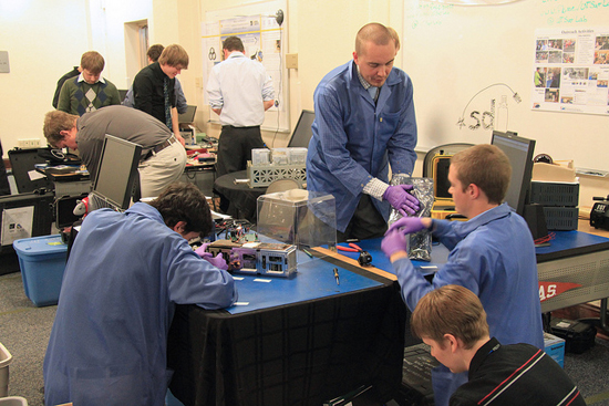 the ARMADILLO team works on setting up its competition display