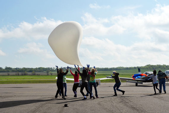 Extremely high winds made for a very difficult launch. The balloon is shown here seriously deformed from high winds. WIALD team members scrambled to keep the balloon off the ground while the payload teams ran downwind.