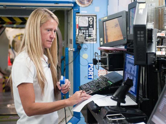 Karen Nyberg, Expedition 36/37 flight engineer, participates in a routine operations training session in an International Space Station mock-up/trainer in the Space Vehicle Mock-up Facility at NASA
