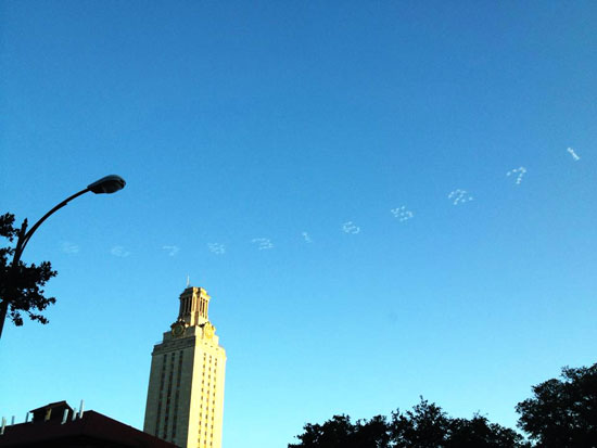 numbers of pi skywritten above the UT tower
