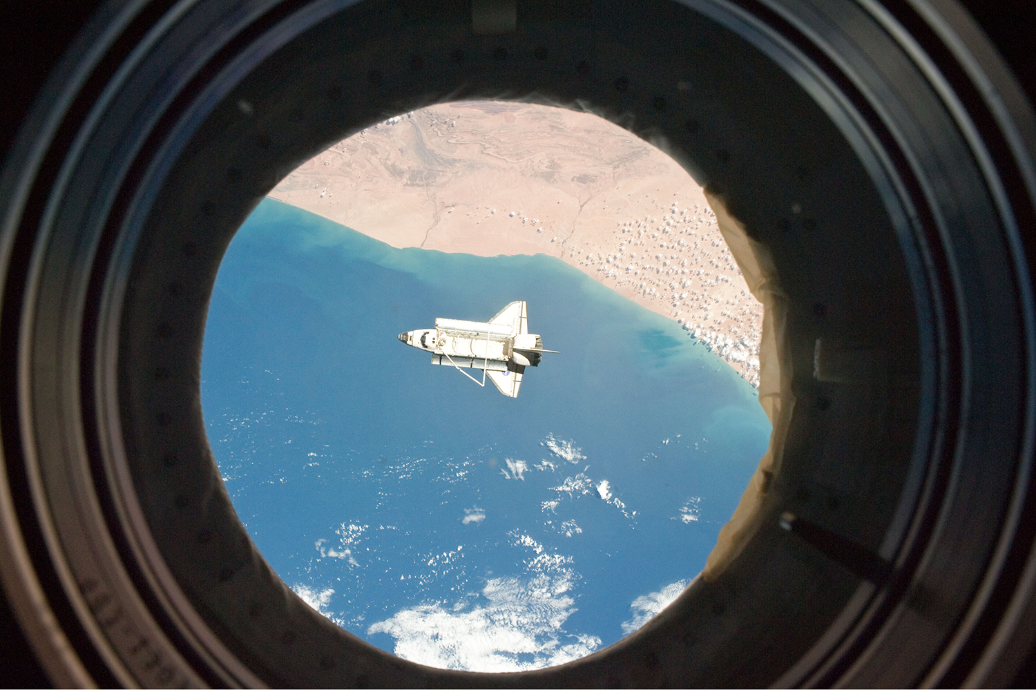 This picture, taken from the International Space Station, shows the space shuttle Discovery over the northern Atlantic Ocean 