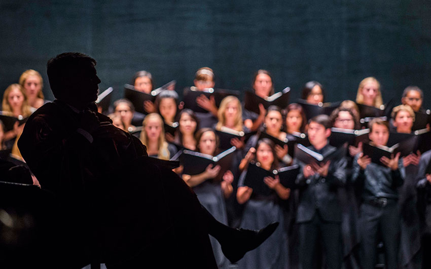 President Fenves enjoys the music by UT Austin choirs.
