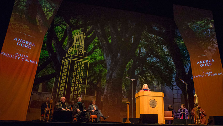 Andrea Gore, chair of the Faculty Council, emcees the inauguration ceremony.
