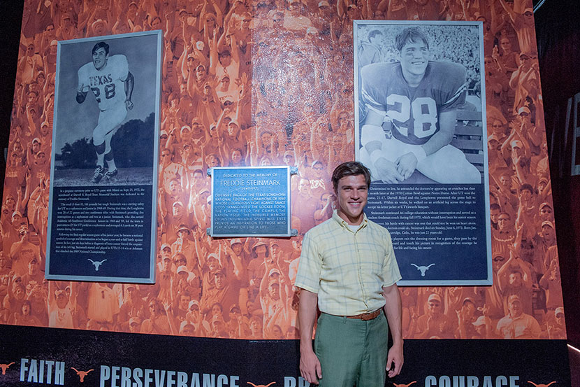 Finn Wittrock, the actor who plays Longhorns Legend Freddie Steinmark in the upcoming movie My All American, poses in front o