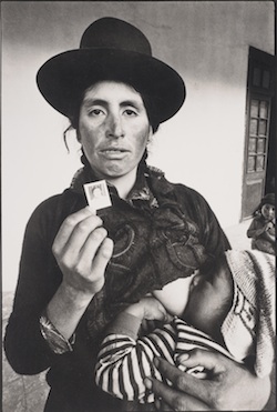 Woman with child and photograph of missing husband. Ayacucho, Peru