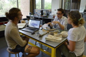 From Left, Daniel Goodwin, Sean Riley and Rebecca Milton brainstorming ways to improve an early prototype of the violin at The Foundry.