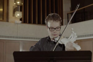 Riley performing with the final 3-D printed violin.