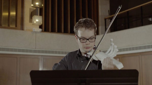 Riley performing with the final 3-D printed violin.