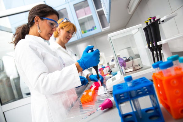 Scientists researching in laboratory.