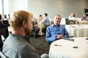 Vice President for Research Dan Jaffe (right) listens to Andrew Esbaugh from the Marine Science Institute.