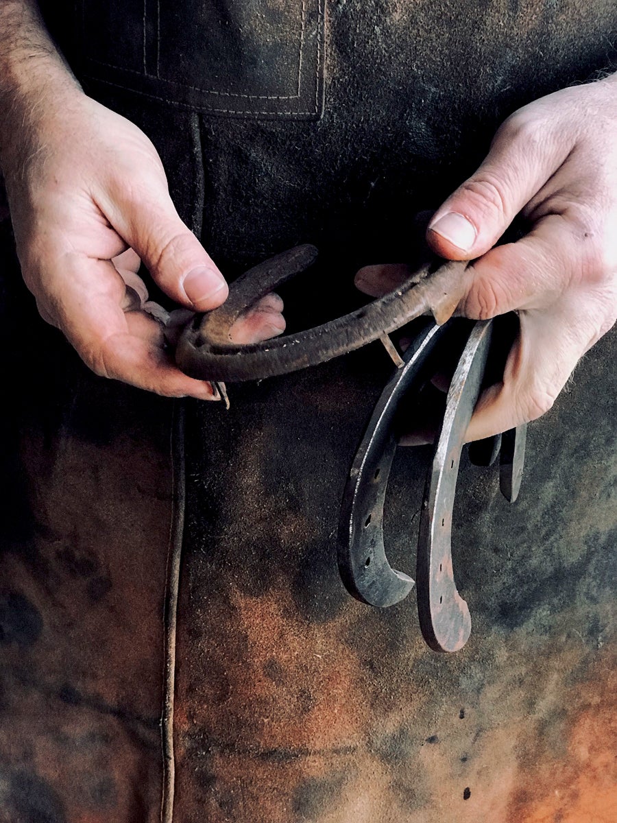 Everett holding some of his handmade horseshoes. 