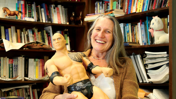 Janet Davis, holding a Rock figurine.
