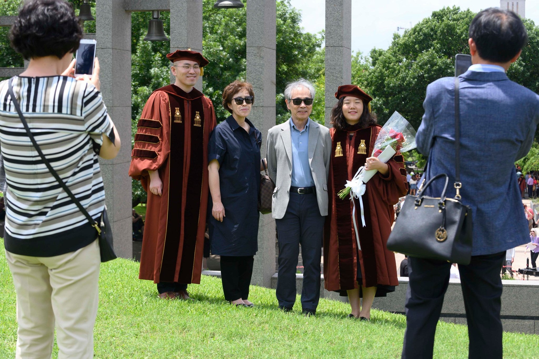 Asian family posing for graduation photos. Asian family posing for graduation photos.