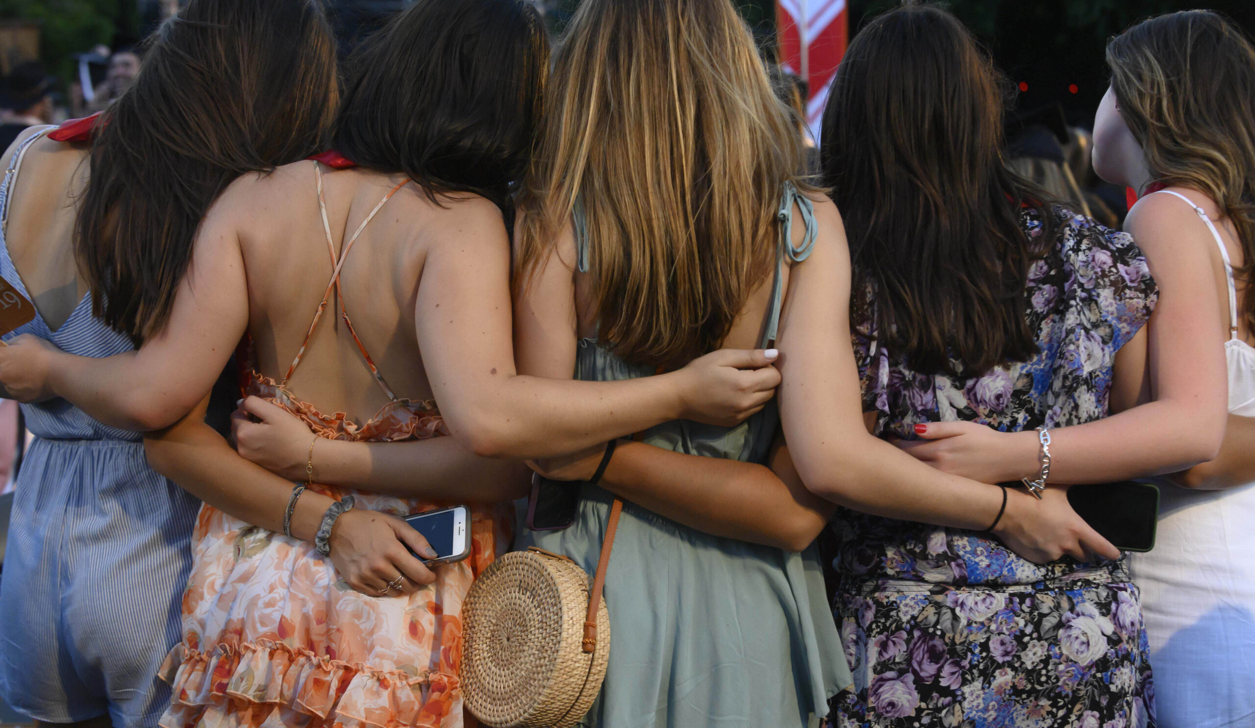 Friends posing for a photo at graduation.