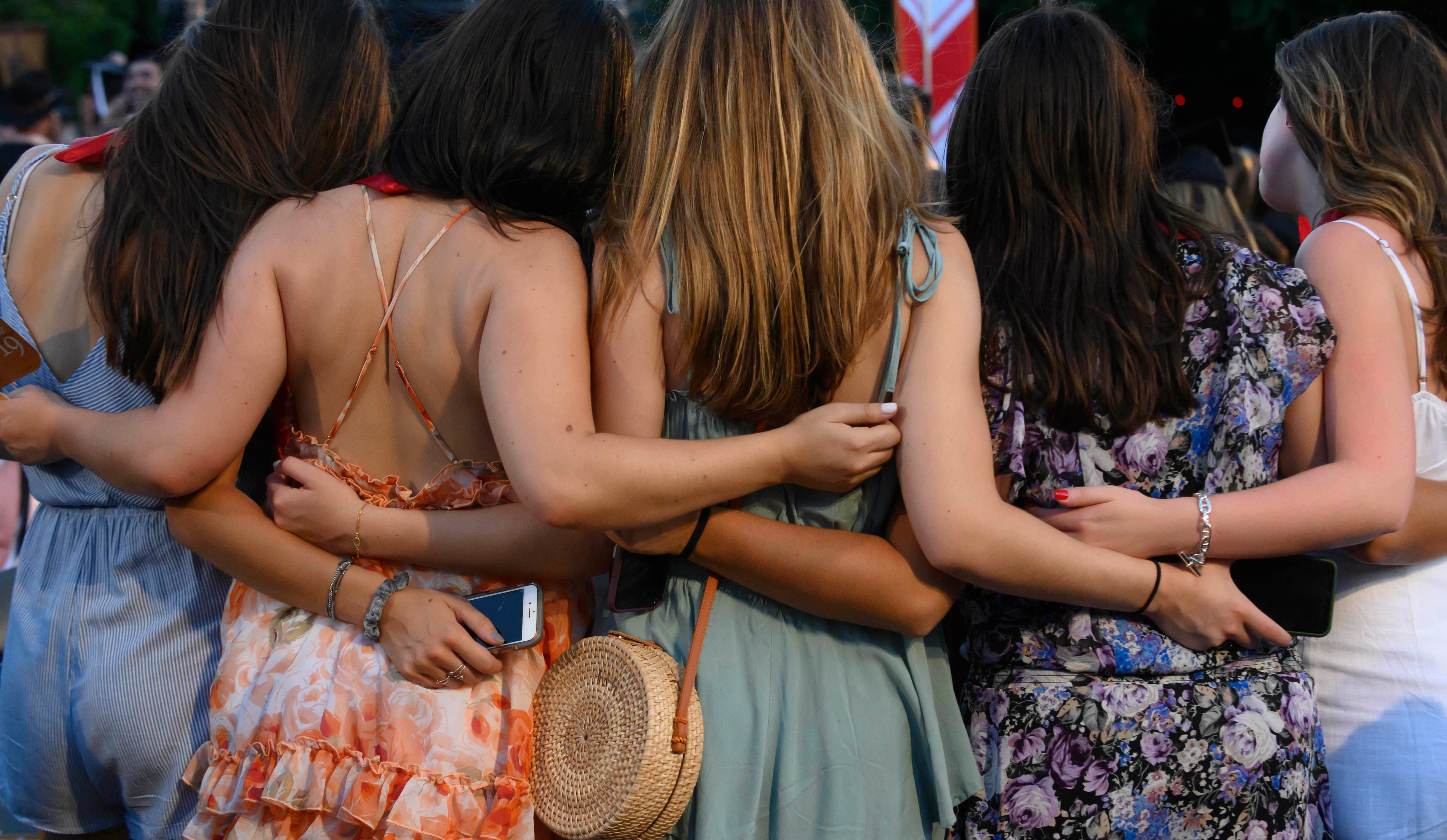 Friends posing for a photo at graduation.