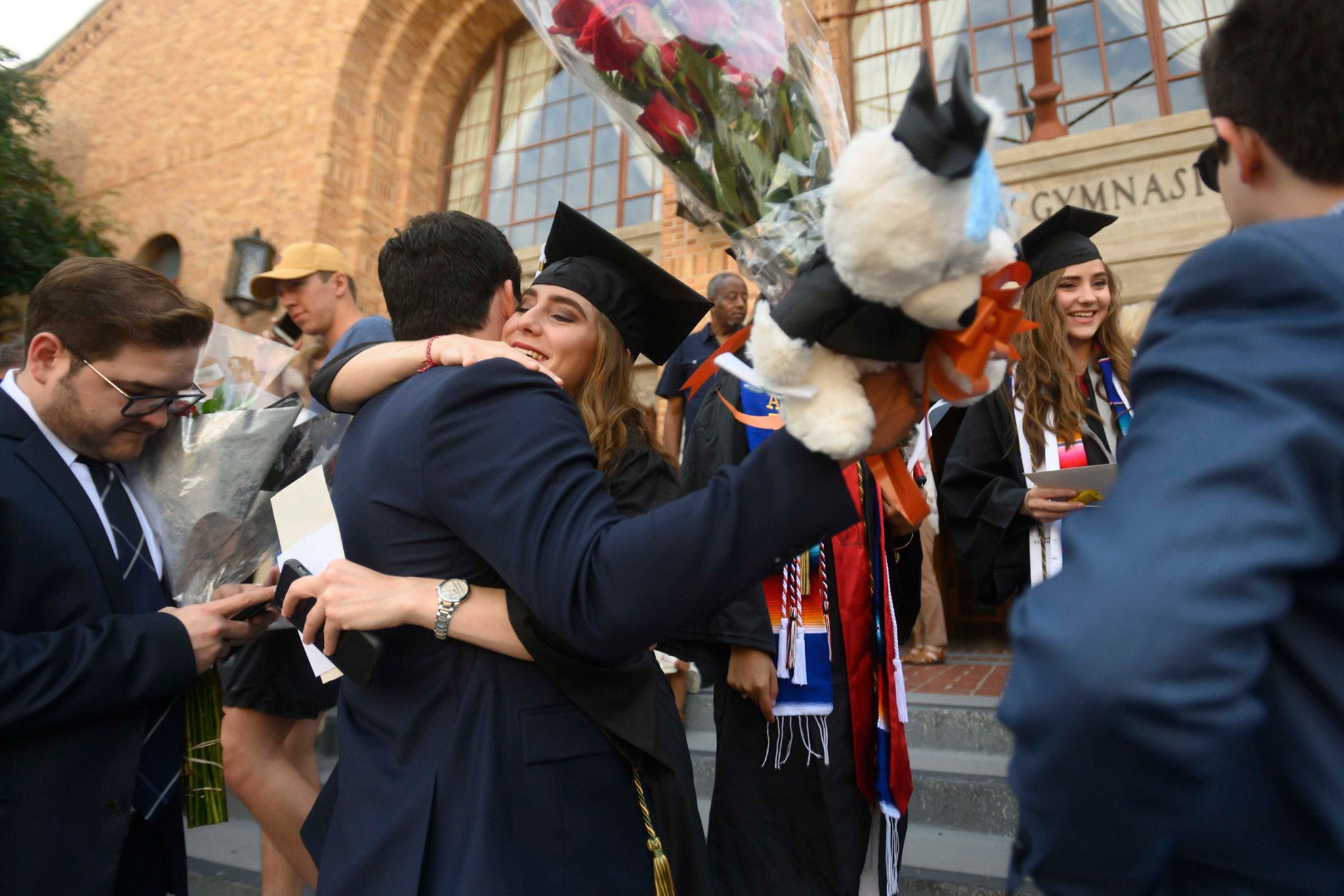 Hugging graduates.
