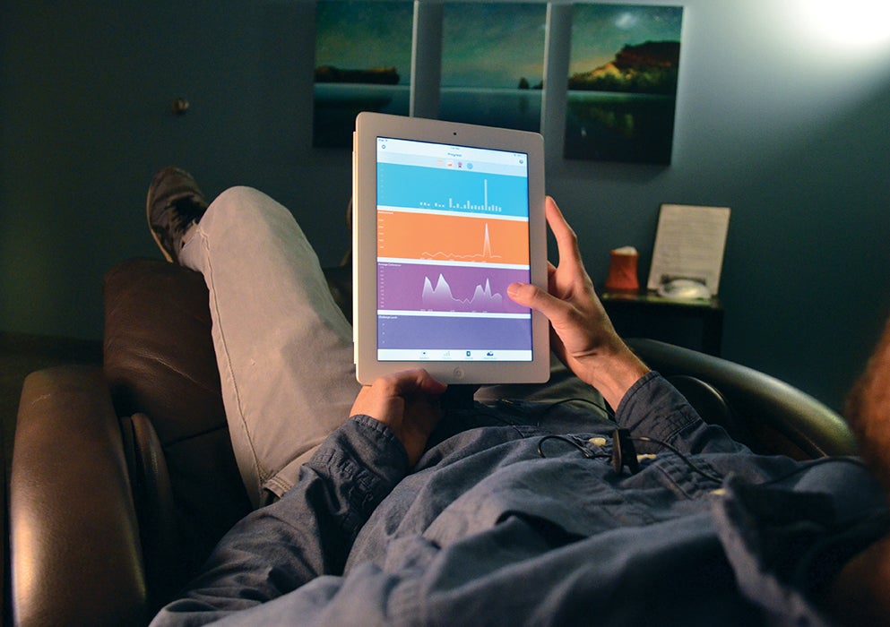 A staff member sits in the zero-gravity chair.