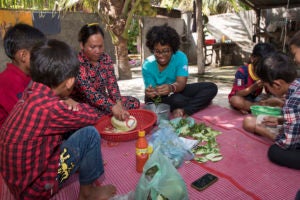 Student working with family prepping a meal.