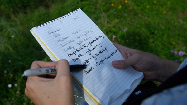 Dr. Susan Cameron Devitt produces a collection vial from her waist pack, harvests the insect, and jots a few words in her notebook.