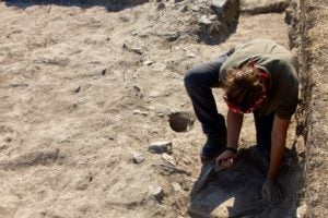 Student digs in a trench