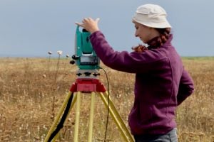 Student operates a surveying device