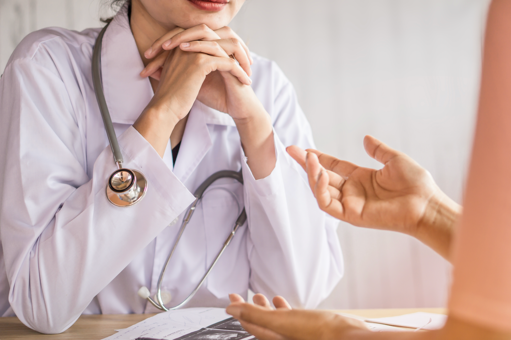 Female doctor talking to a female patient.