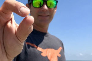 Jace Tunnell holds a nurdle found on a Texas beach.