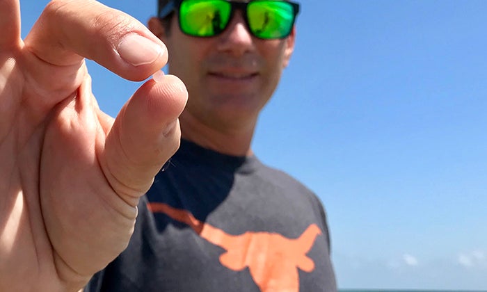 Jace Tunnell holds a nurdle found on a Texas beach.