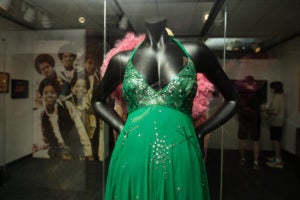 A photo of a green dress decorated with sequins.