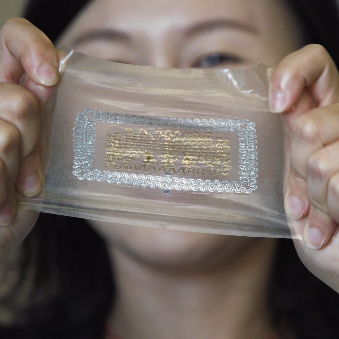 Nanshu Lu stretches the e-tattoo designed to monitor heart health.