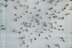 Aerial photo of a crowd with data grids projected on ground.
