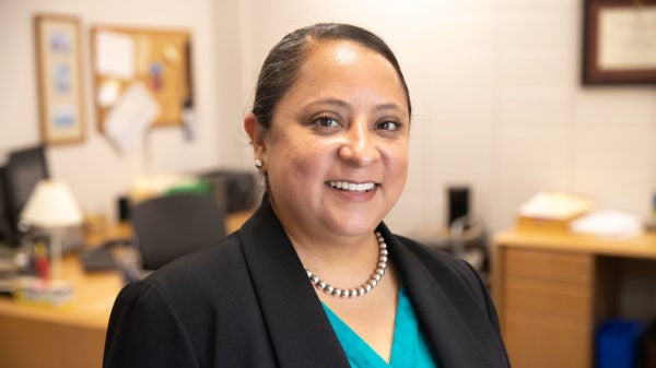 A woman sits in an office.