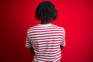 Young afro man with dreadlocks wearing striped t-shirt