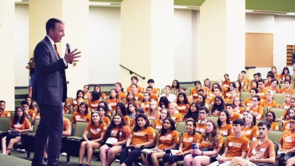 Jay Hartzell, classroom, students, Gone to Texas, burnt orange shirts, teaching, speaking with mic