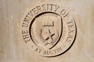 seal, university, limestone, texas union, wall