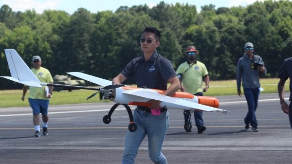 Hyeonseung “Shawn” Lee maneuvers Phoenix III, the competition aircraft of UT Austin’s Unmanned Aerial Vehicle Team.