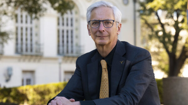 Art Markman sits outside on campus in a suit