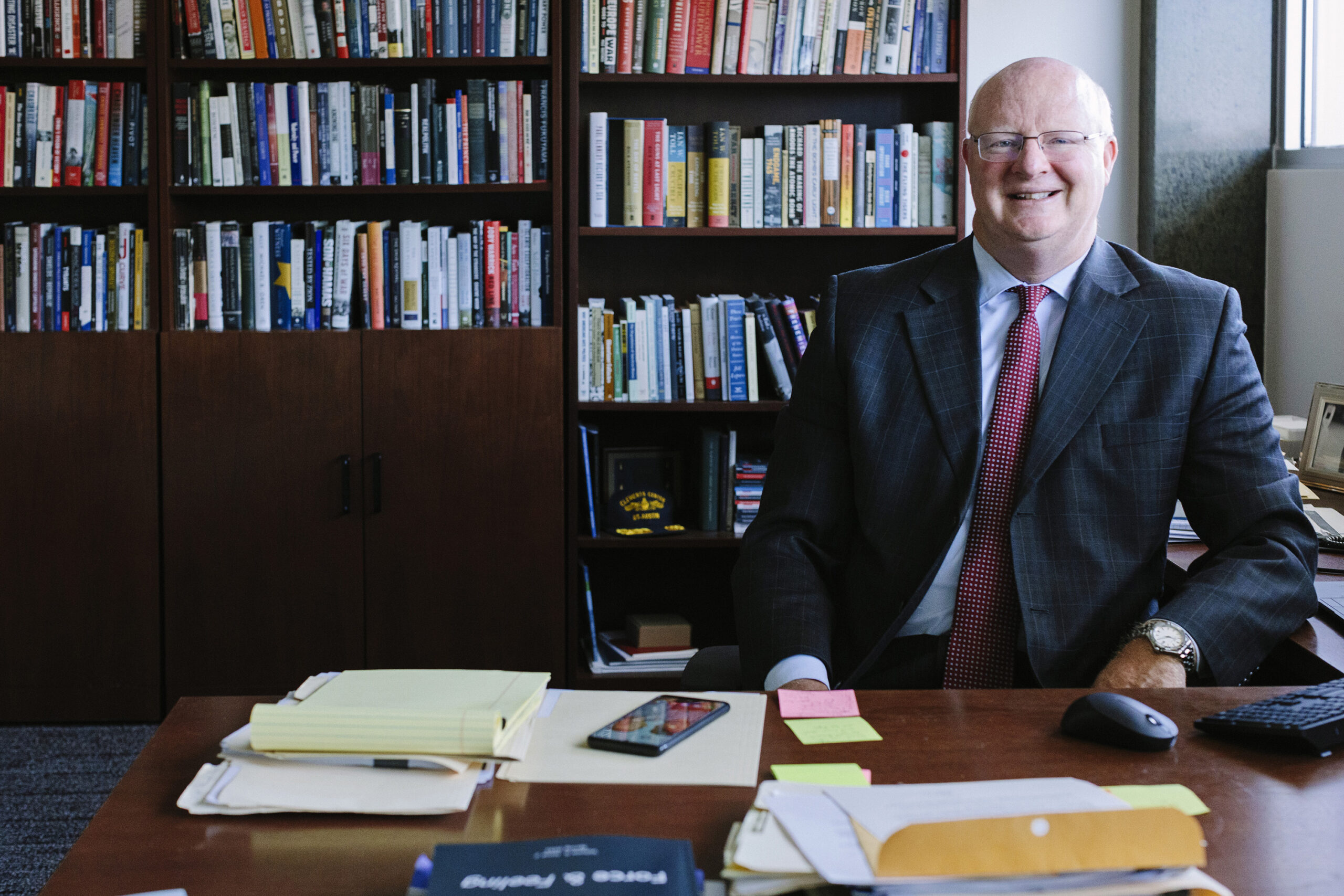 Will Inboden smiles at office desk