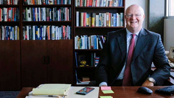 Will Inboden smiles at office desk