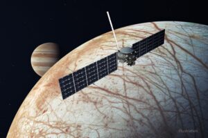 Europa Clipper with extended solar panels over Europa with Jupiter in the distance.