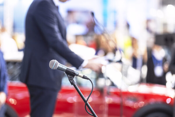 Public speaking concept. Speaker giving a speech at business conference, presentation or media event.