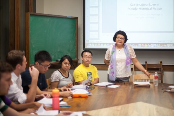 Chiu-Mi Lai with students in class sitting around a table
