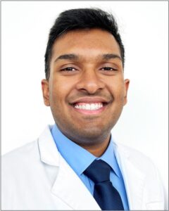 arjun menta in white coat and tie