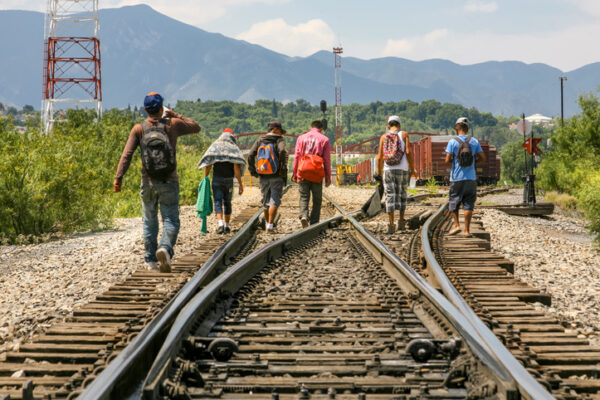 A group of migrants walk along the railroad near the US-Mexico border in the state of Coahuila in northern Mexico