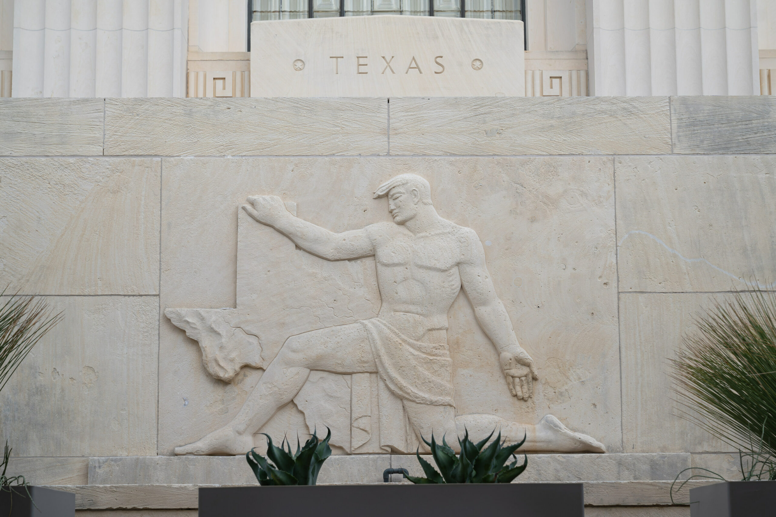 Exterior frieze of man with state of Texas